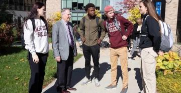 RIC interim president and students outside
