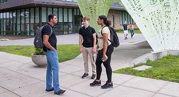 Students talking near sculpture